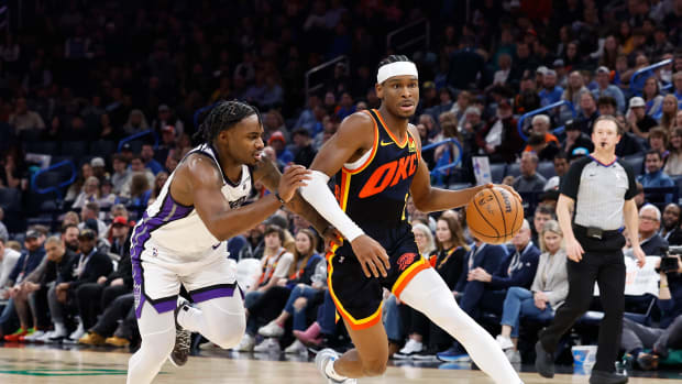 Feb 11, 2024; Oklahoma City, Oklahoma, USA; Oklahoma City Thunder guard Shai Gilgeous-Alexander (2) drives to the basket beside Sacramento Kings guard Davion Mitchell (15) during the second half at Paycom Center. Mandatory Credit: Alonzo Adams-USA TODAY Sports  